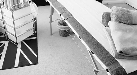 Massage table and towels at Radiant Wellness in King's Lynn, England, GB for relaxing treatment.