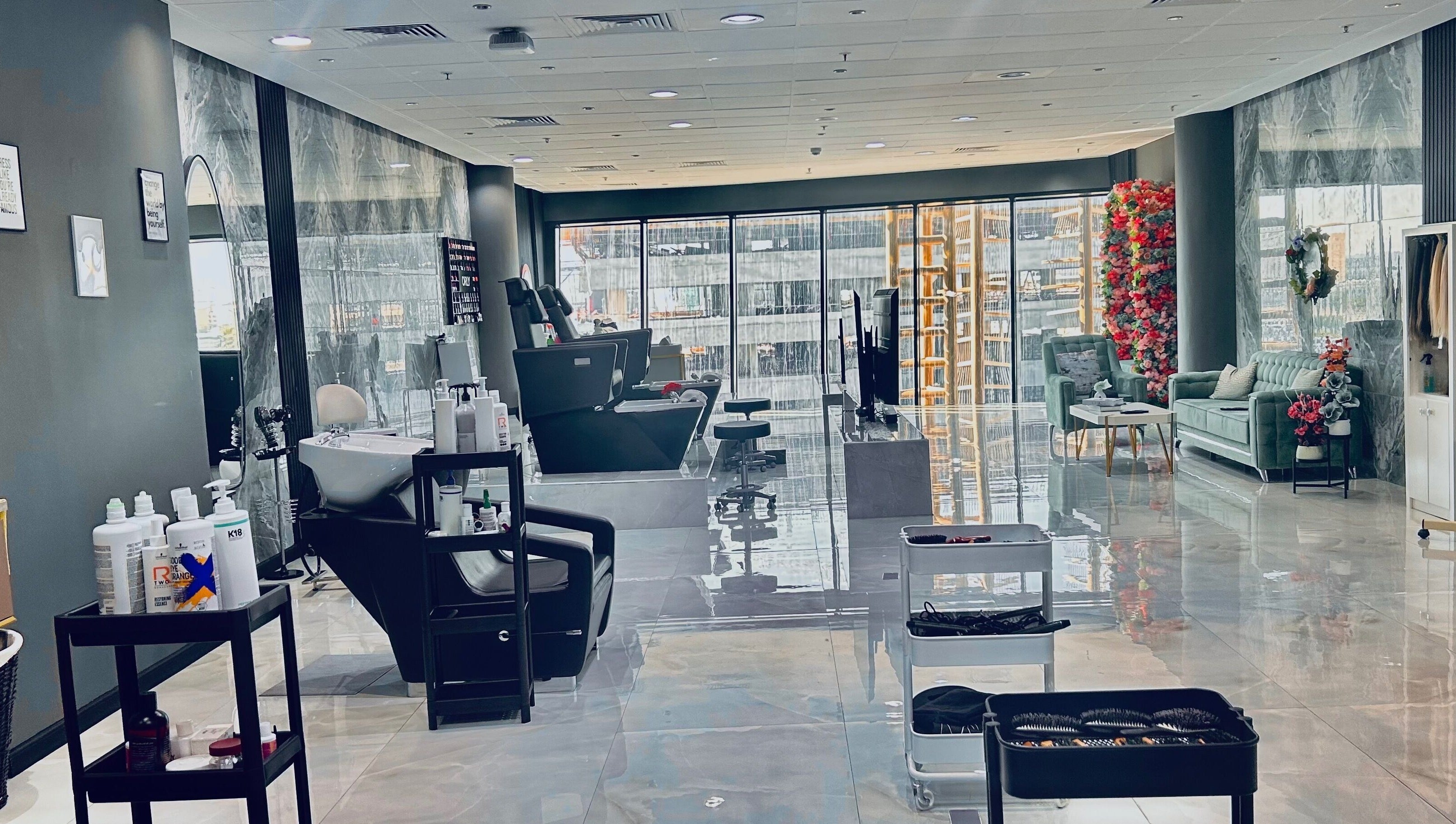 Chic interior of Enigmabeautysalon in Lusail, Al Daayen Municipality, QA, highlighting plush seating and sleek salon chairs.