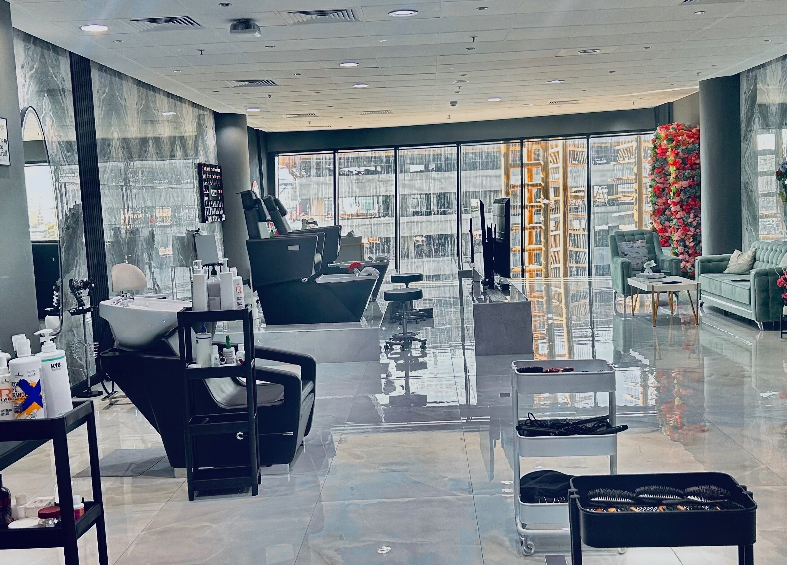 Chic interior of Enigmabeautysalon in Lusail, Al Daayen Municipality, QA, highlighting plush seating and sleek salon chairs.