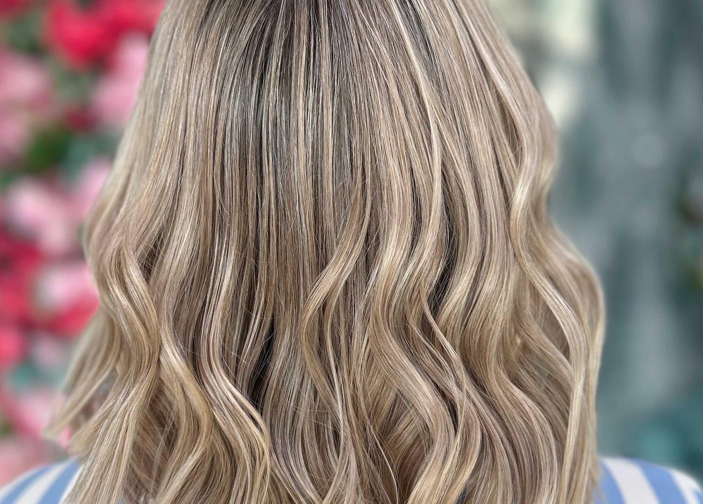 Blonde wavy hair at Enigmabeautysalon, Lusail, Al Daayen Municipality, QA. Vibrant hair styling and color.