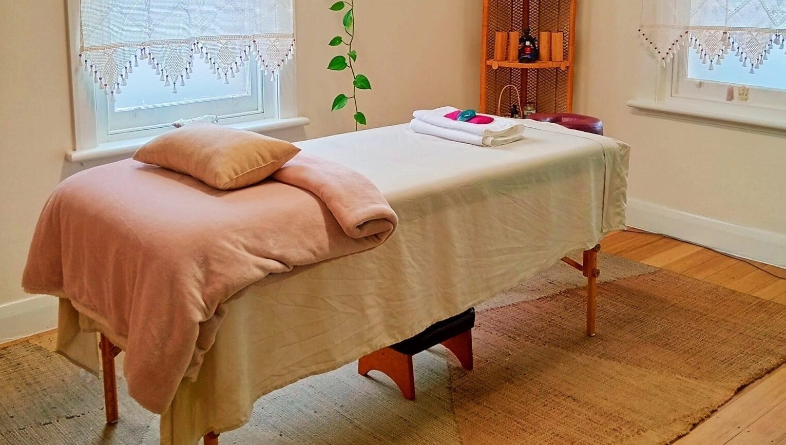 Relaxing massage room at The Temple Of Bliss, Colac, Victoria, AU, featuring a cozy treatment table.