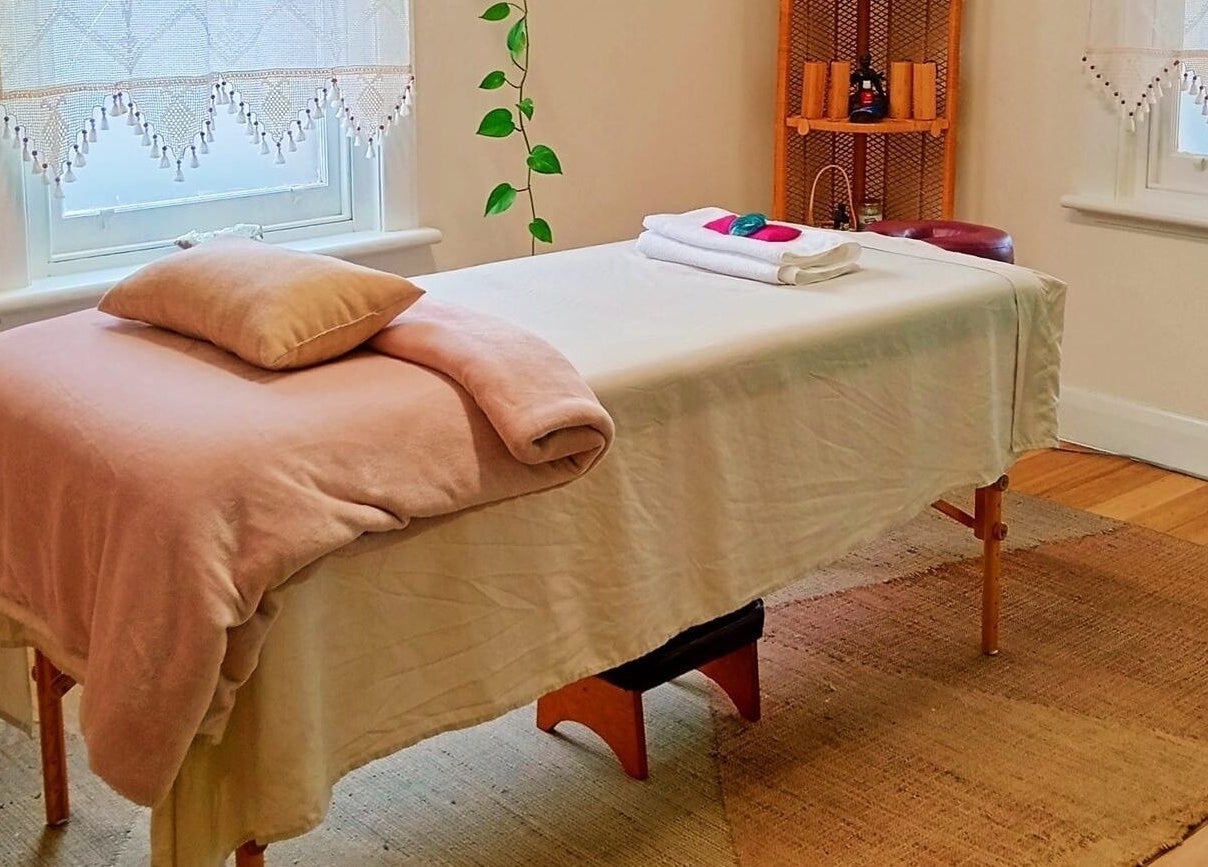 Relaxing massage room at The Temple Of Bliss, Colac, Victoria, AU, featuring a cozy treatment table.