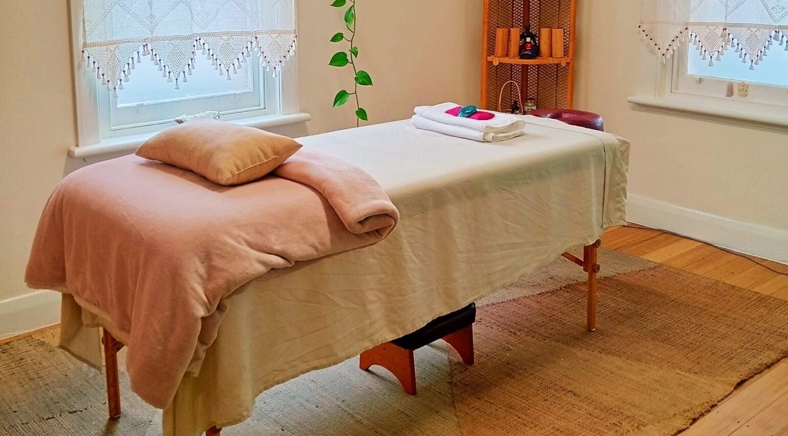 Relaxing massage room at The Temple Of Bliss, Colac, Victoria, AU, featuring a cozy treatment table.
