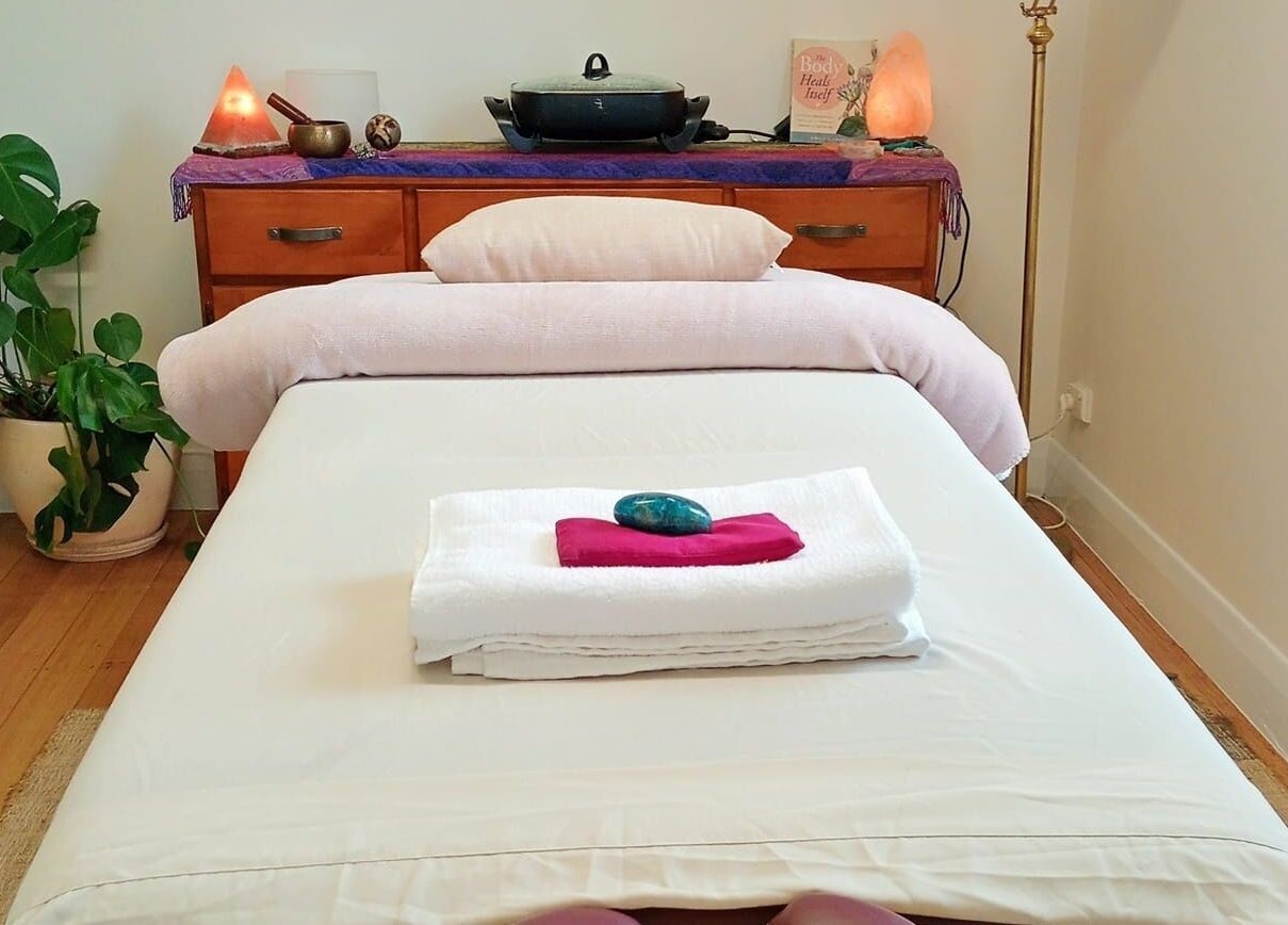 Relaxing massage room at The Temple Of Bliss in Colac, Victoria, AU with a cozy bed and calming decor.