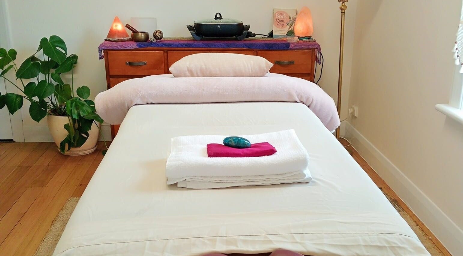 Relaxing massage room at The Temple Of Bliss in Colac, Victoria, AU with a cozy bed and calming decor.
