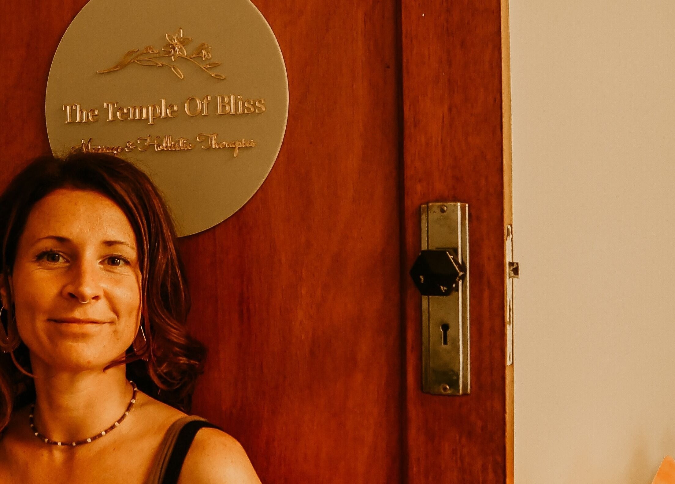 Welcoming entrance at The Temple Of Bliss in Colac, Victoria, AU with elegant wooden door and sign.