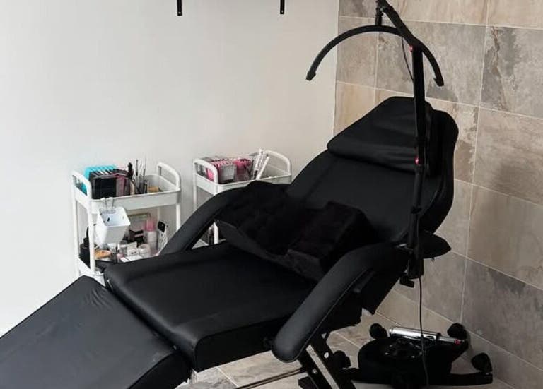 Comfortable beauty treatment chair at Nbnailz, Maryport, England, GB, with tools and supplies in view.