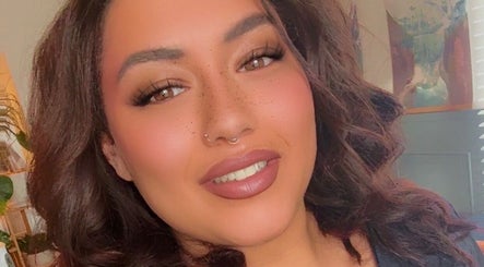 Smiling staff member at Beauty by Liv, Bourne, England, GB, welcoming clients with warmth and professionalism.