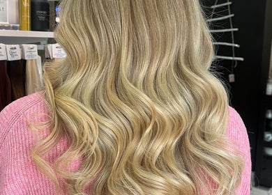 Blonde wavy hairstyle at Bethany Jade Hairdressing, Cannock, England, GB, showcasing elegant curls.