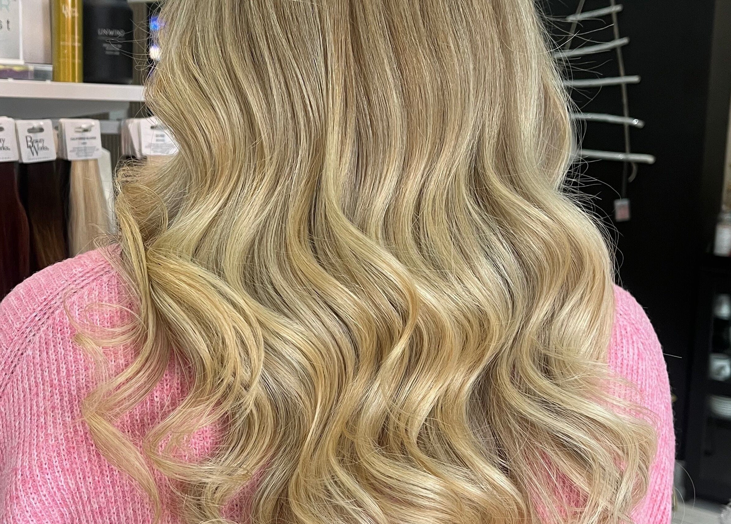 Blonde wavy hairstyle at Bethany Jade Hairdressing, Cannock, England, GB, showcasing elegant curls.