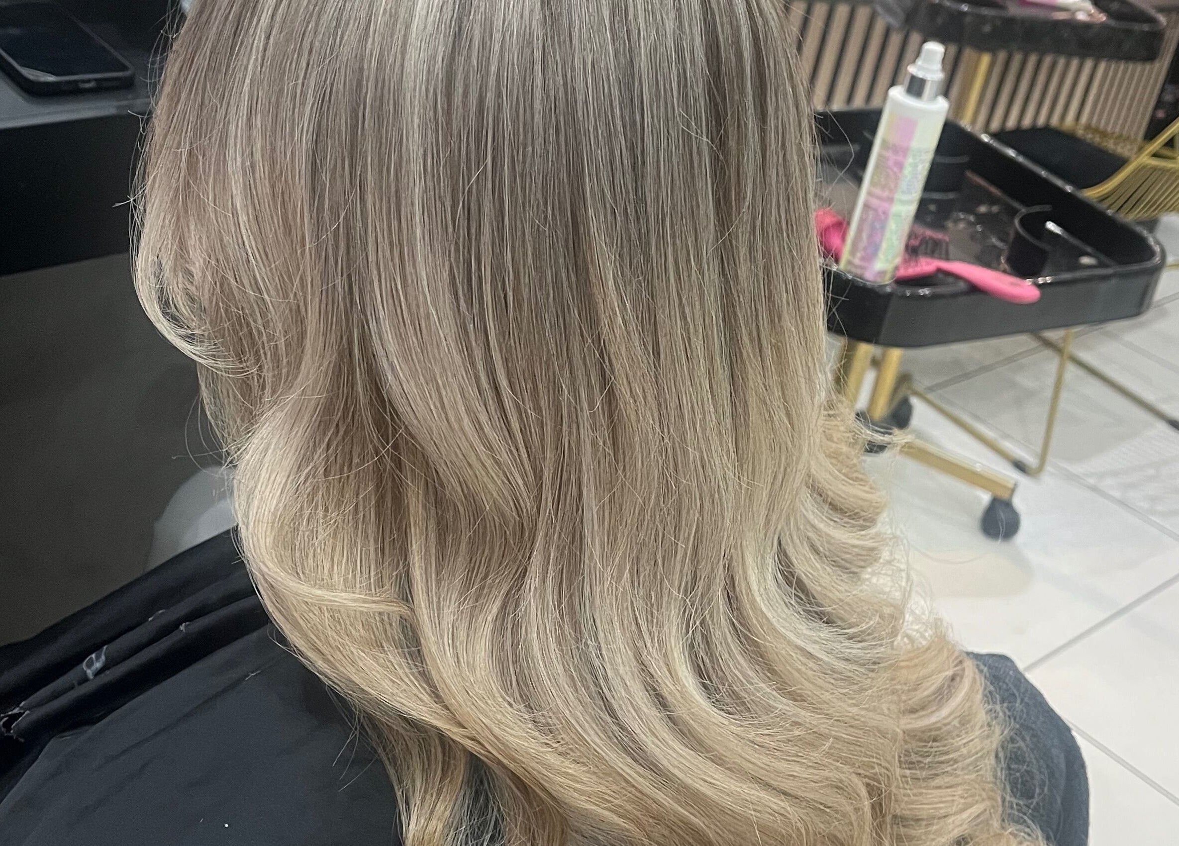Blonde hair with soft waves styled at Bethany Jade Hairdressing in Cannock, England, GB.