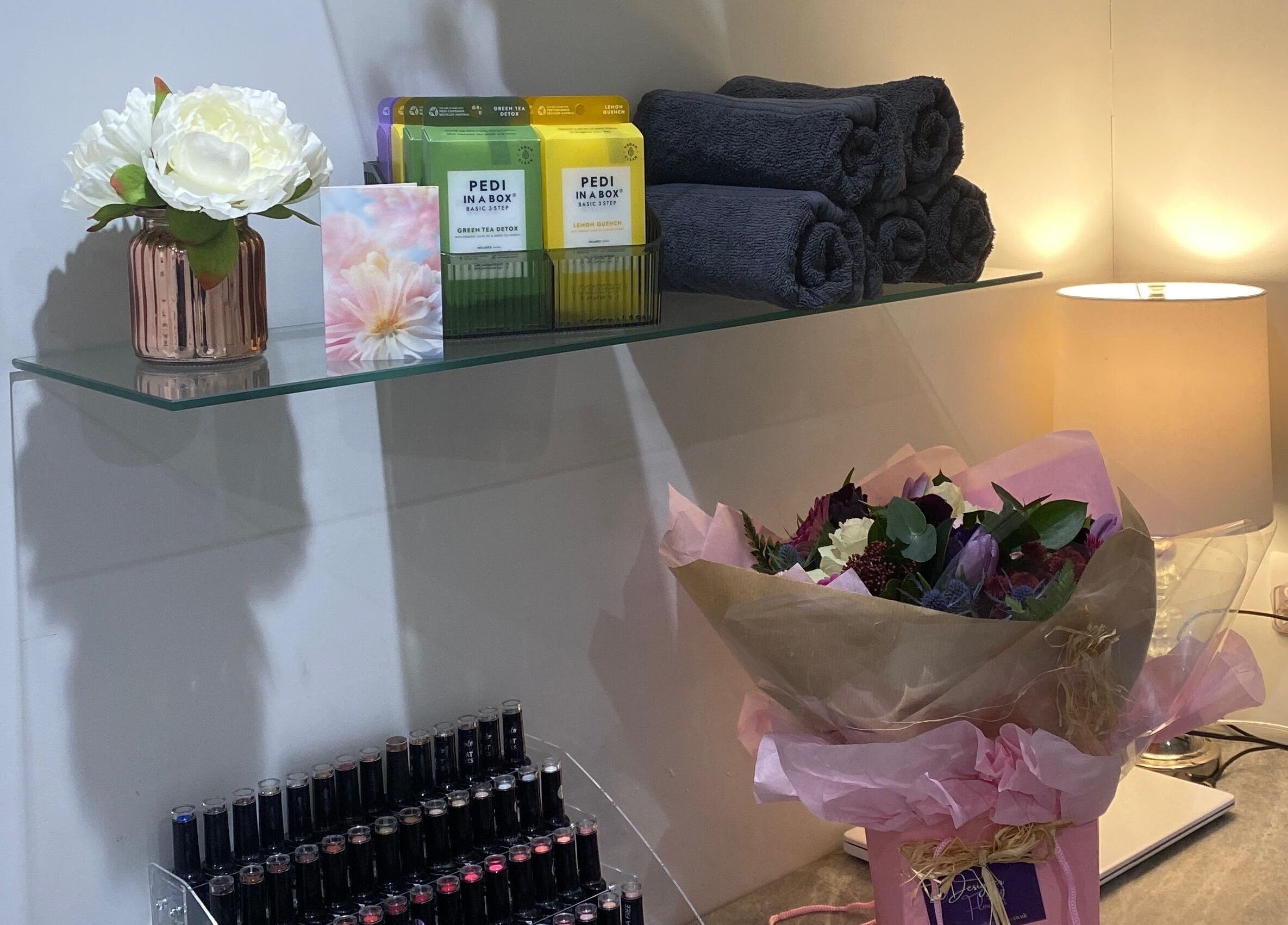 Elegant decor with flowers and towels at Nails and More at No.4, Ross-on-Wye, England, GB.