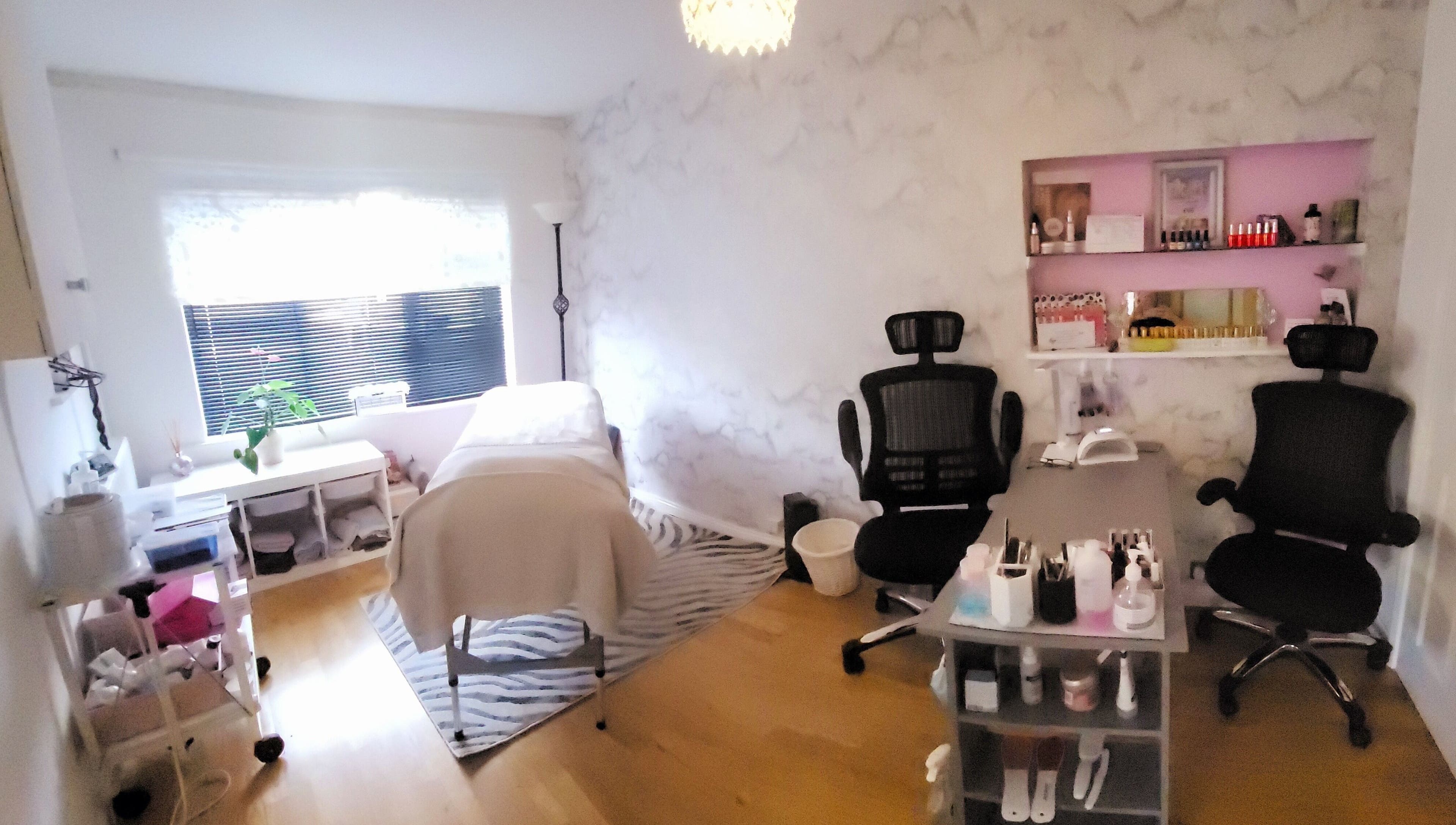 Beautiques therapy room in Fleet, England, GB featuring treatment bed and elegant decor.
