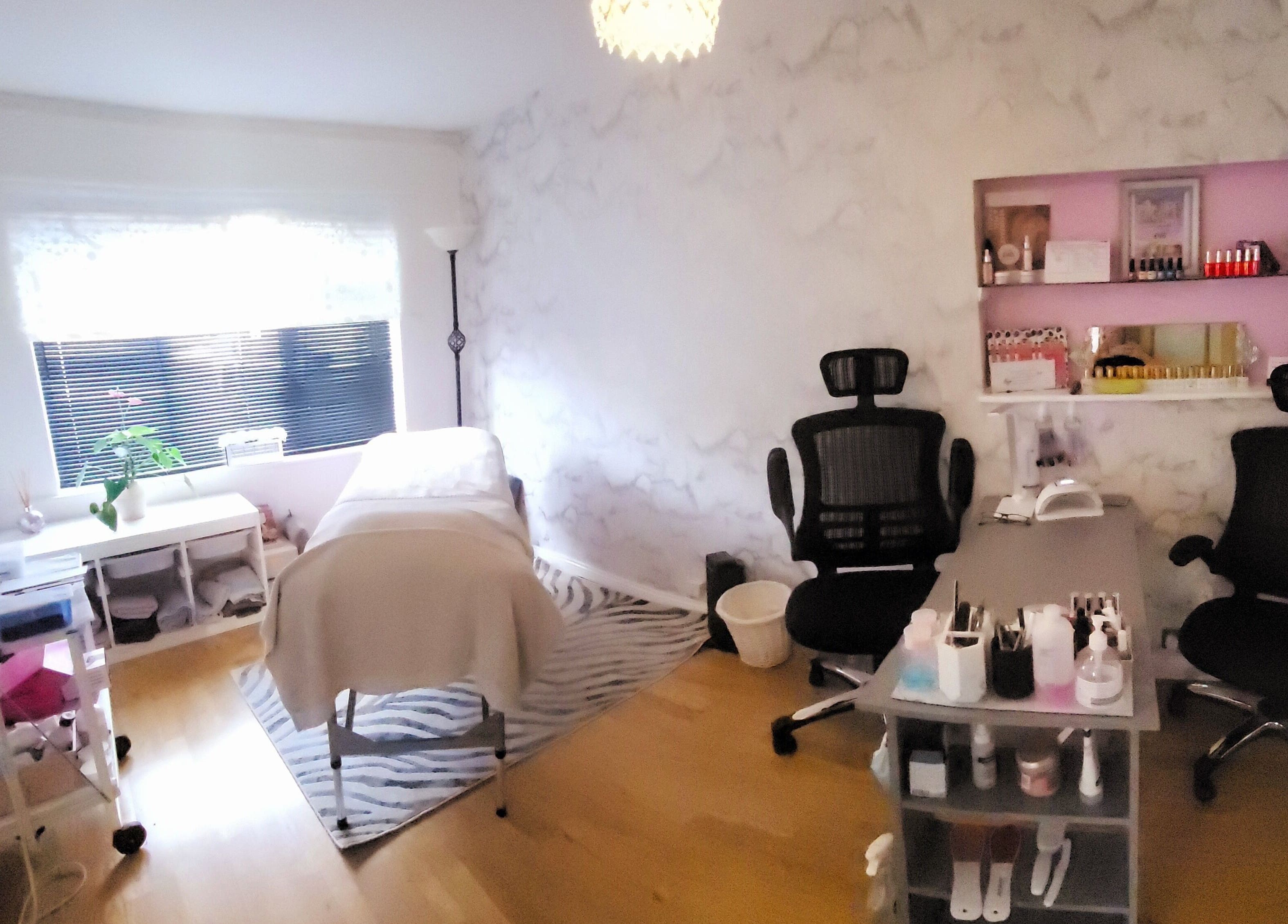 Beautiques therapy room in Fleet, England, GB featuring treatment bed and elegant decor.