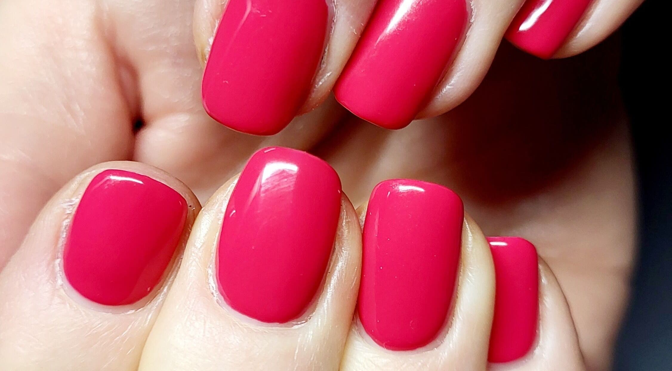 Perfectly manicured red nails at Beautiques, Fleet, England, GB highlight elegance and style.