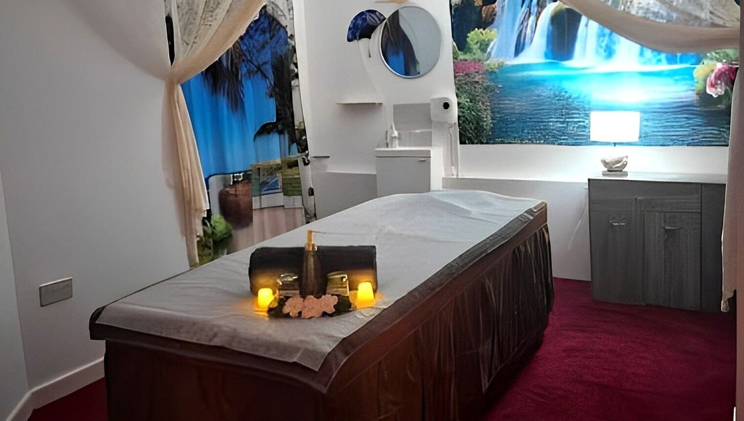 Tranquil massage room at Shewa Thai Massage & Spa, Stoke-on-Trent, England, GB, featuring a soothing waterfall mural.