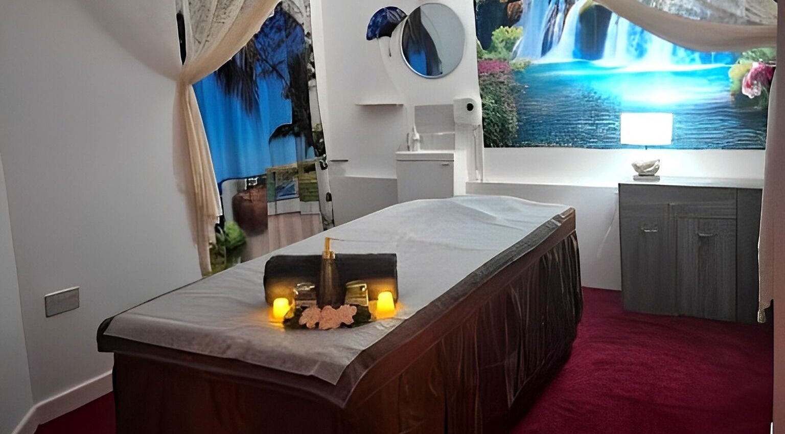 Tranquil massage room at Shewa Thai Massage & Spa, Stoke-on-Trent, England, GB, featuring a soothing waterfall mural.