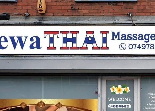 Entrance of Shewa Thai massage & Spa in Stoke-on-Trent, England, showcasing signage and floral design.