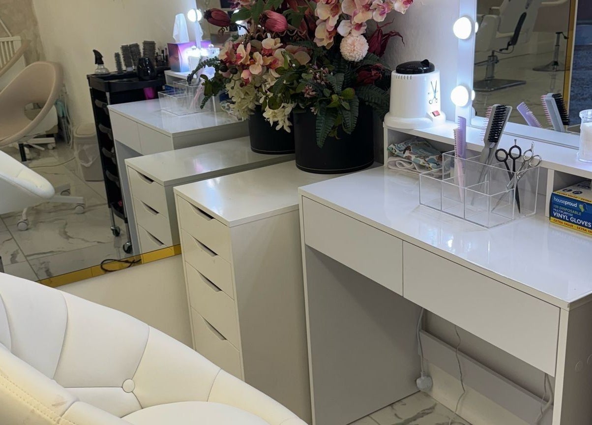 Chic vanity at Mona, Glasgow, Scotland, GB, with stylish chairs, mirrors, and vibrant flowers.