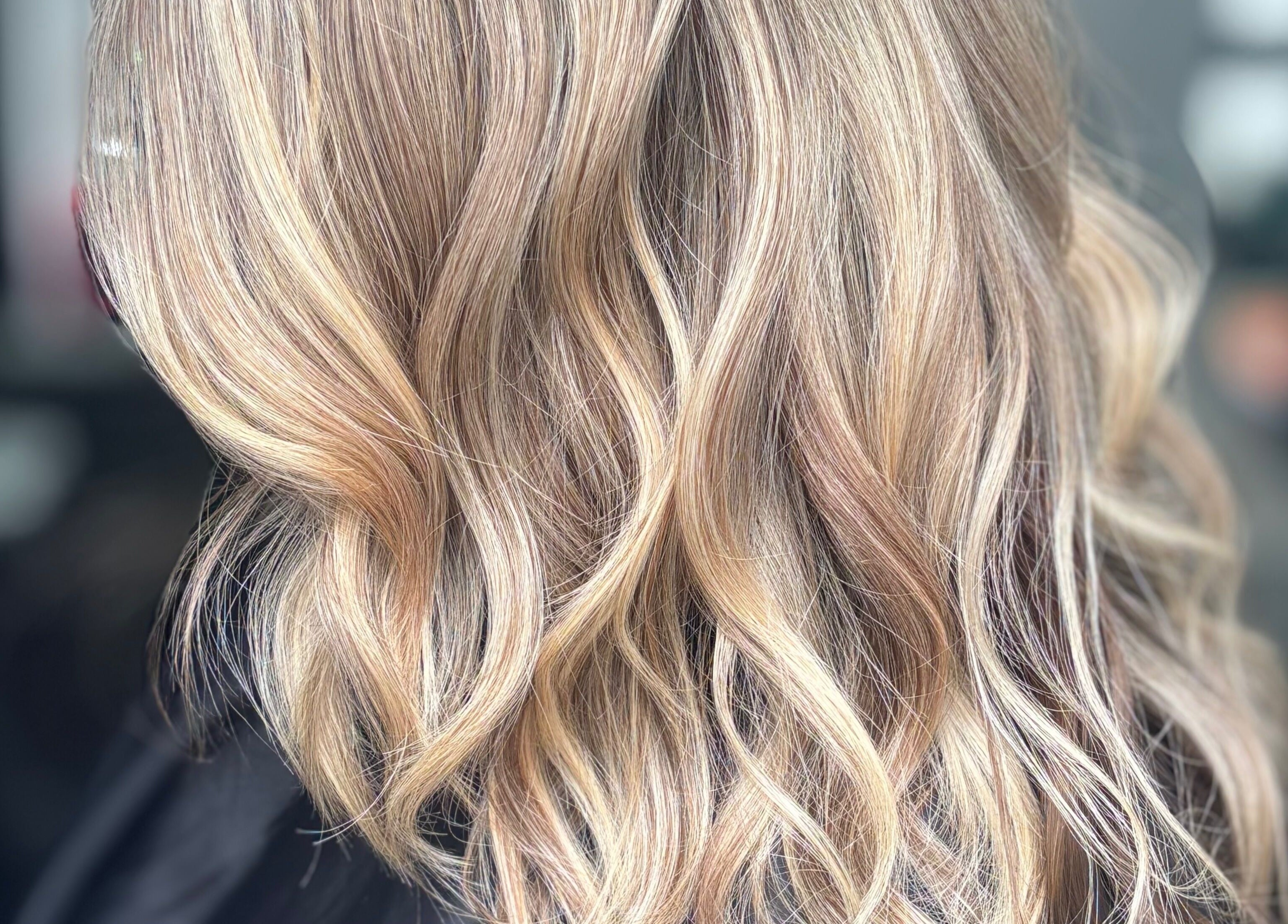 Elegant blonde wavy hairstyle at Hideaway Hair and Beauty, Llandeilo, Wales, GB.