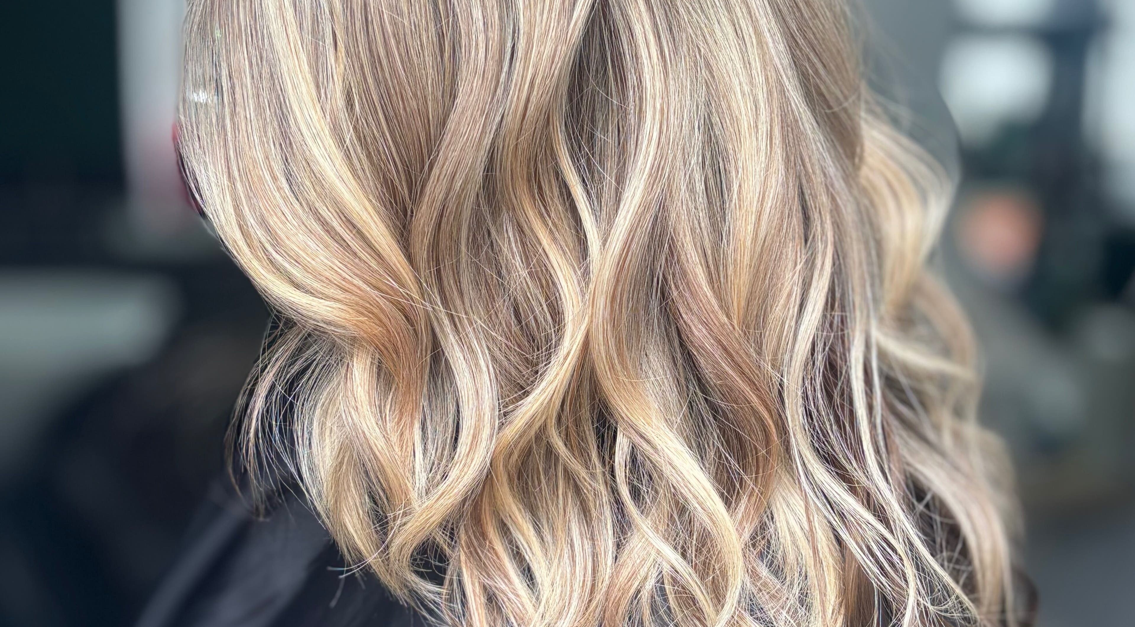 Elegant blonde wavy hairstyle at Hideaway Hair and Beauty, Llandeilo, Wales, GB.