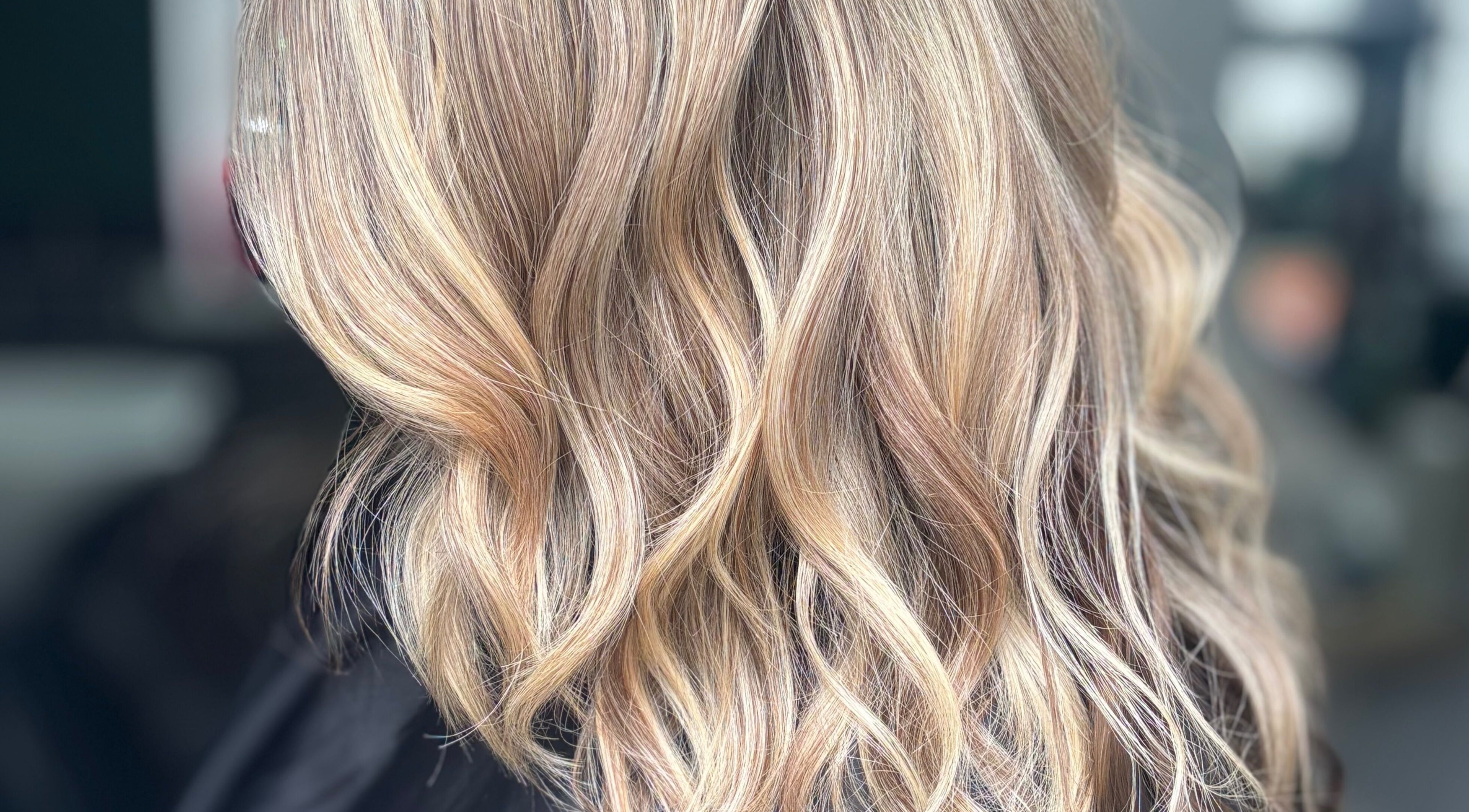 Elegant blonde wavy hairstyle at Hideaway Hair and Beauty, Llandeilo, Wales, GB.