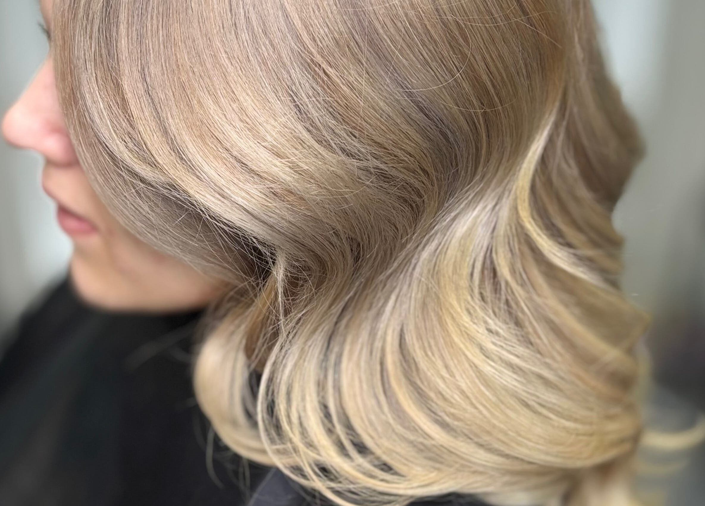 Elegant blonde hair styled in waves at Hideaway Hair and Beauty, Llandeilo, Wales, GB.