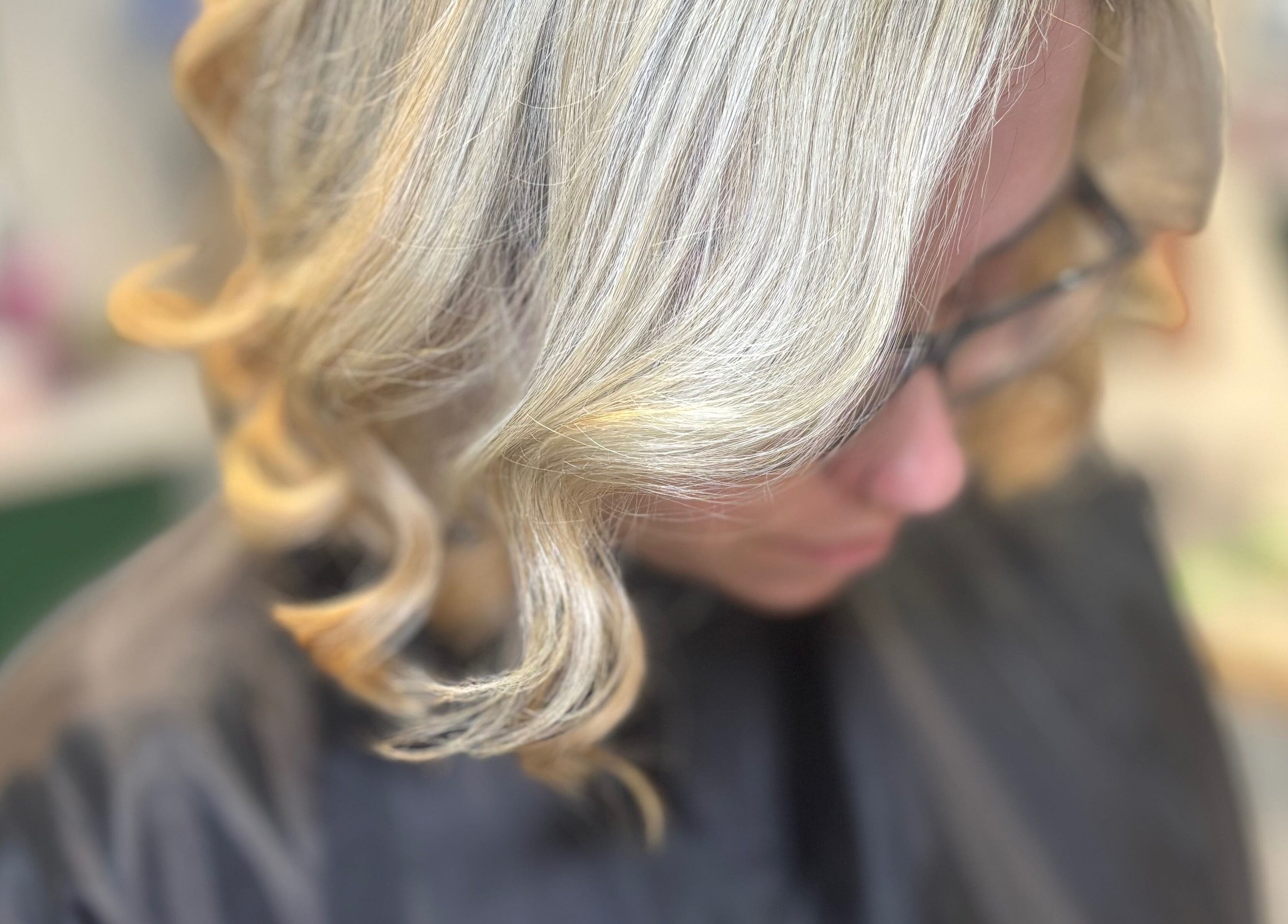 Blonde hair styled in curls at Hideaway Hair and Beauty, Llandeilo, Wales, GB.