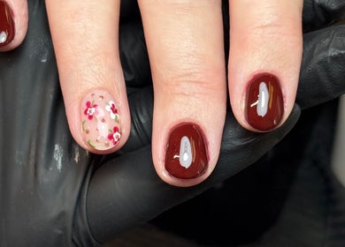 Elegant floral gel nails by Gels by Eleanor in Glasgow, Scotland, GB. Featuring deep red polish and flower art.