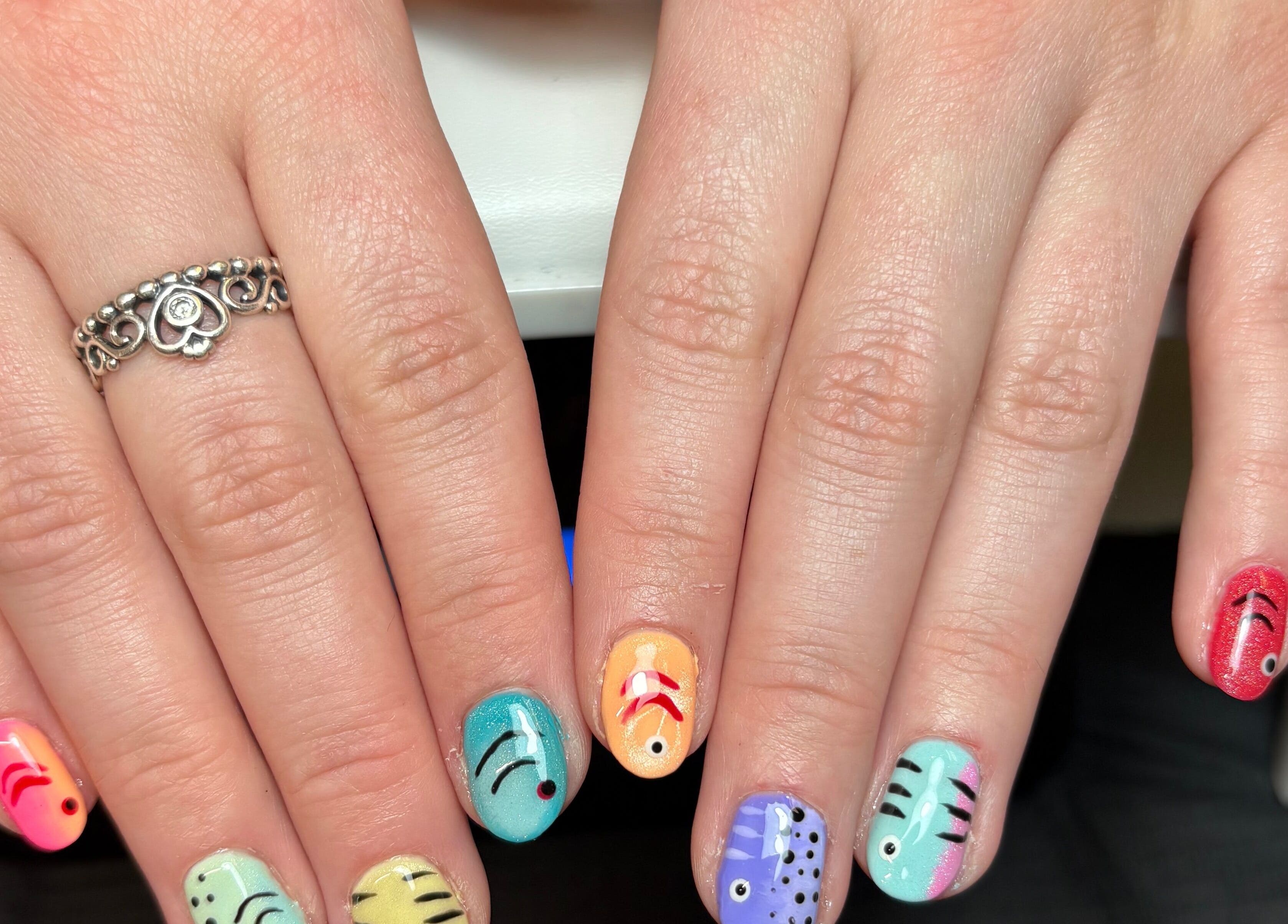 Colorful fish-themed nail art at Gels by Eleanor, a beauty venue in Glasgow, Scotland, GB.