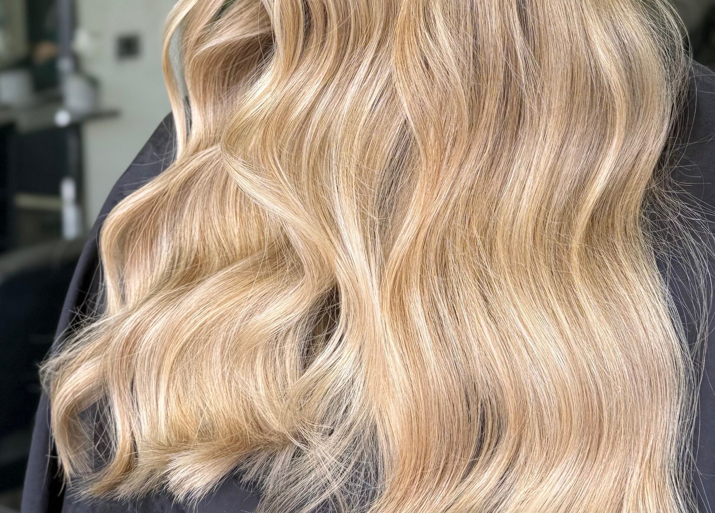 Flowing golden hair styled at Lucy Rose Hair in Smethwick, England, GB.
