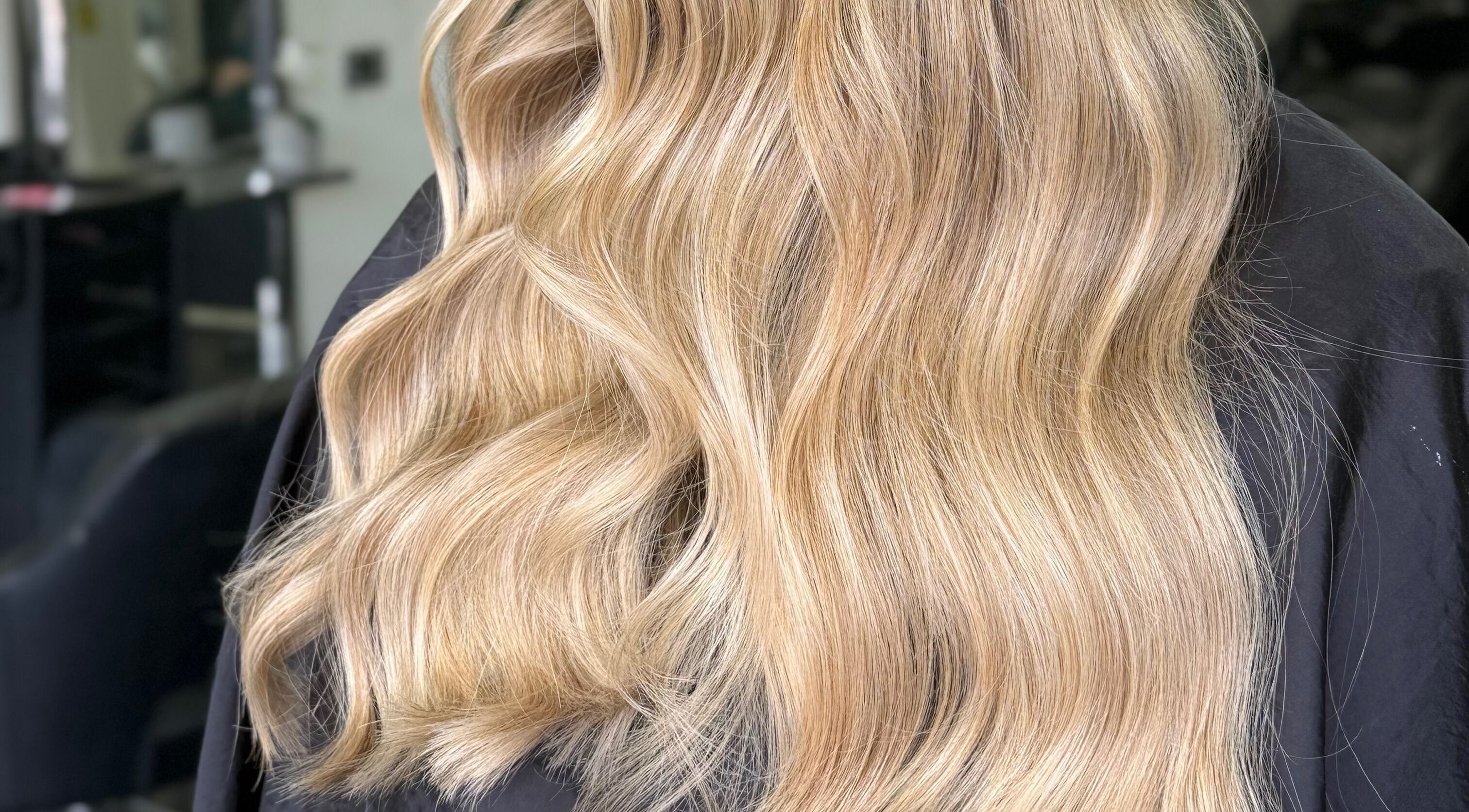 Flowing golden hair styled at Lucy Rose Hair in Smethwick, England, GB.