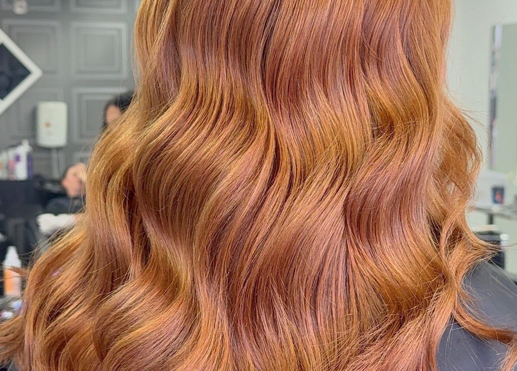 Lustrous wavy hair by Lucy Rose Hair in Smethwick, England, GB, showcasing expert styling and color.