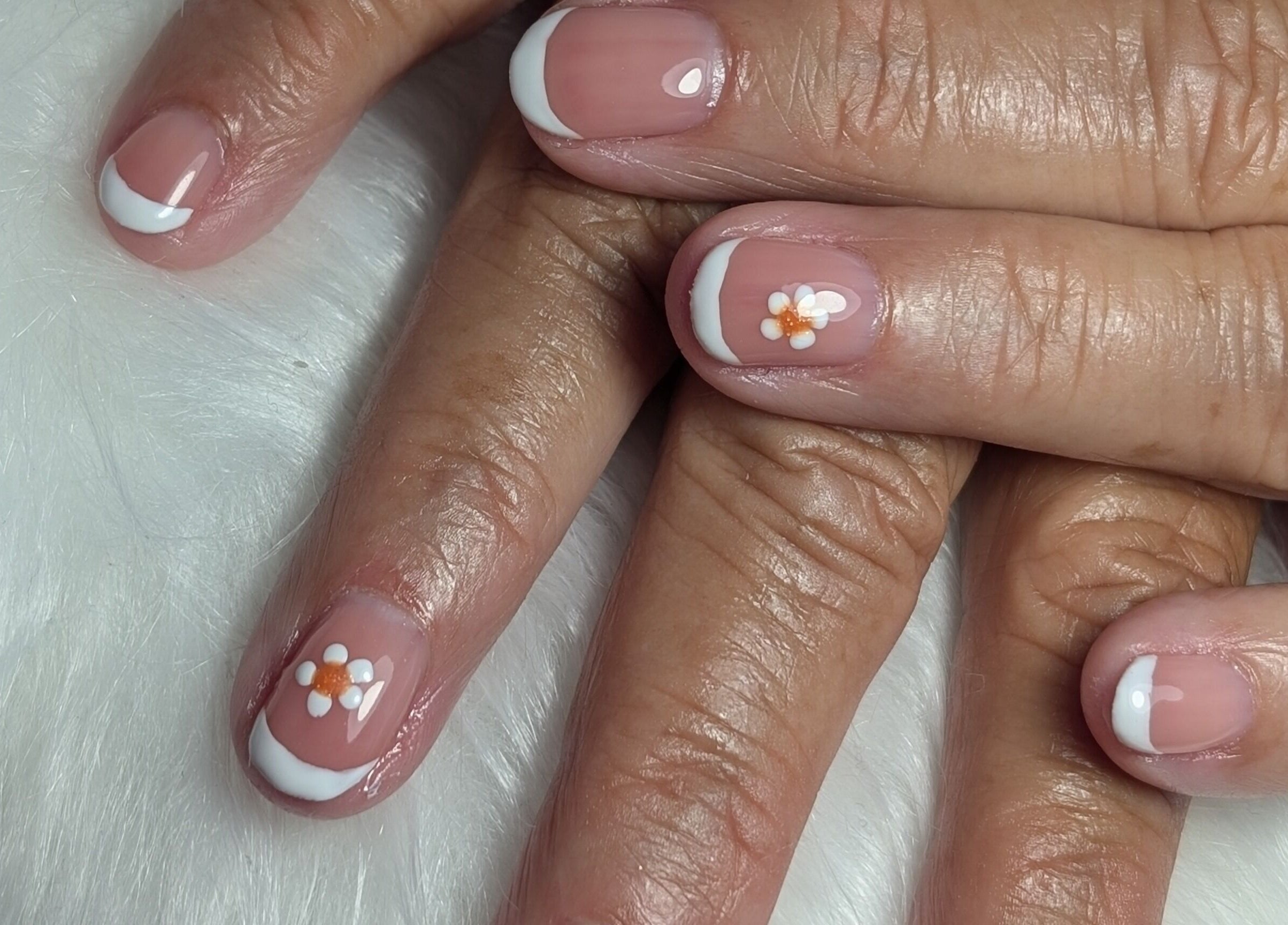 Detailed French manicure with floral design at Peaceful Polish, Burry Port, Wales, GB.
