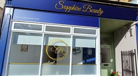 Front of Sapphire Beauty in Lowestoft, England, GB with elegant blue signage and large windows.