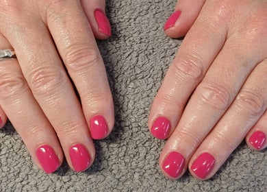 Vibrant pink manicure at Sapphire Beauty in Lowestoft, England, GB, showcasing elegant nail care.