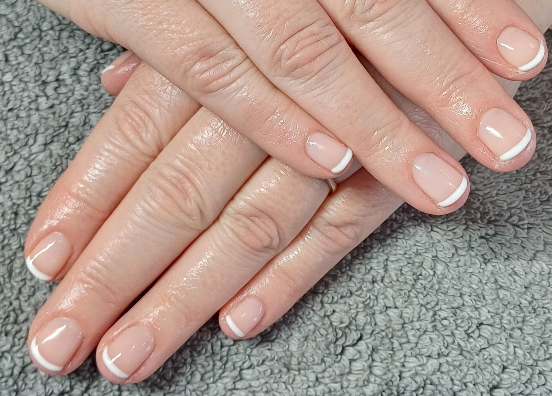 Fresh French manicure at Sapphire Beauty in Lowestoft, England, GB. Perfect nail care and style.