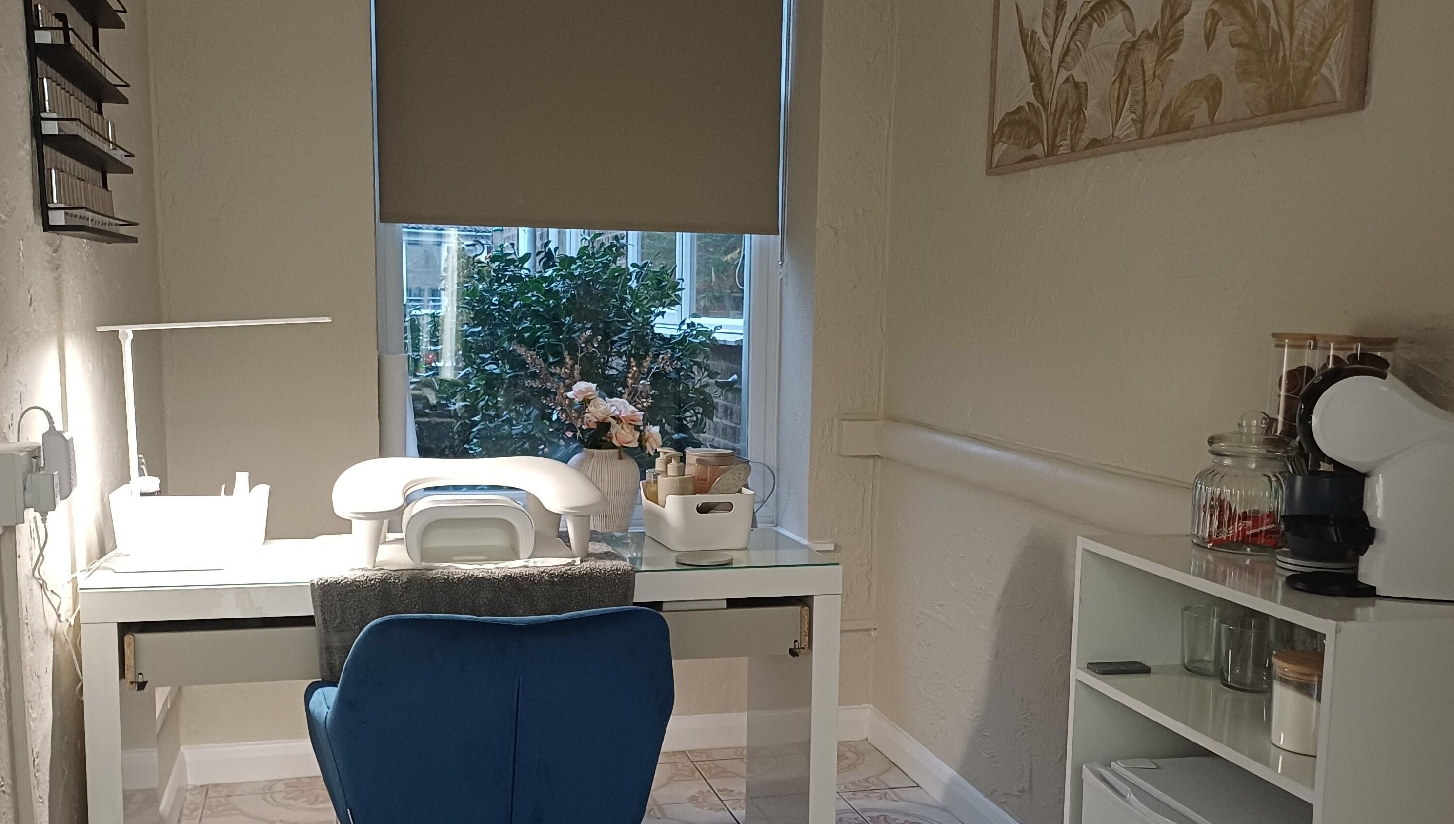 Elegant manicure desk with a blue chair at Sapphire Beauty, Lowestoft, England, GB. Natural light and decor enhance serenity.