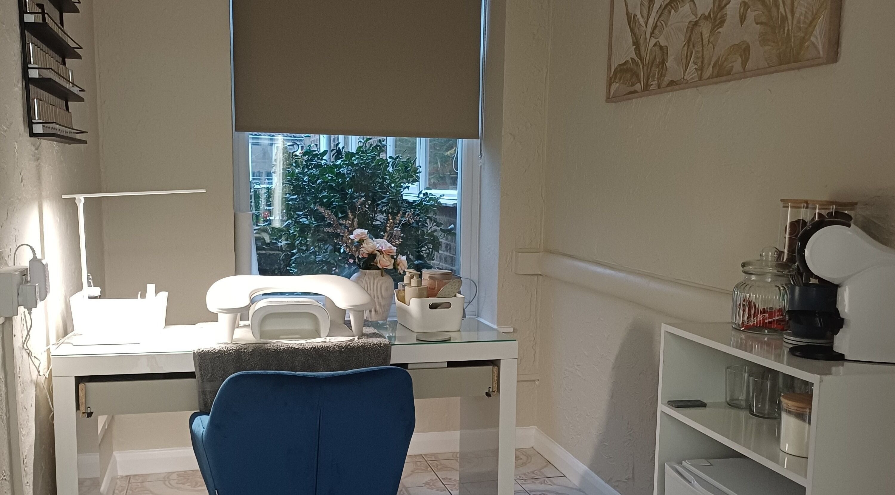 Elegant manicure desk with a blue chair at Sapphire Beauty, Lowestoft, England, GB. Natural light and decor enhance serenity.