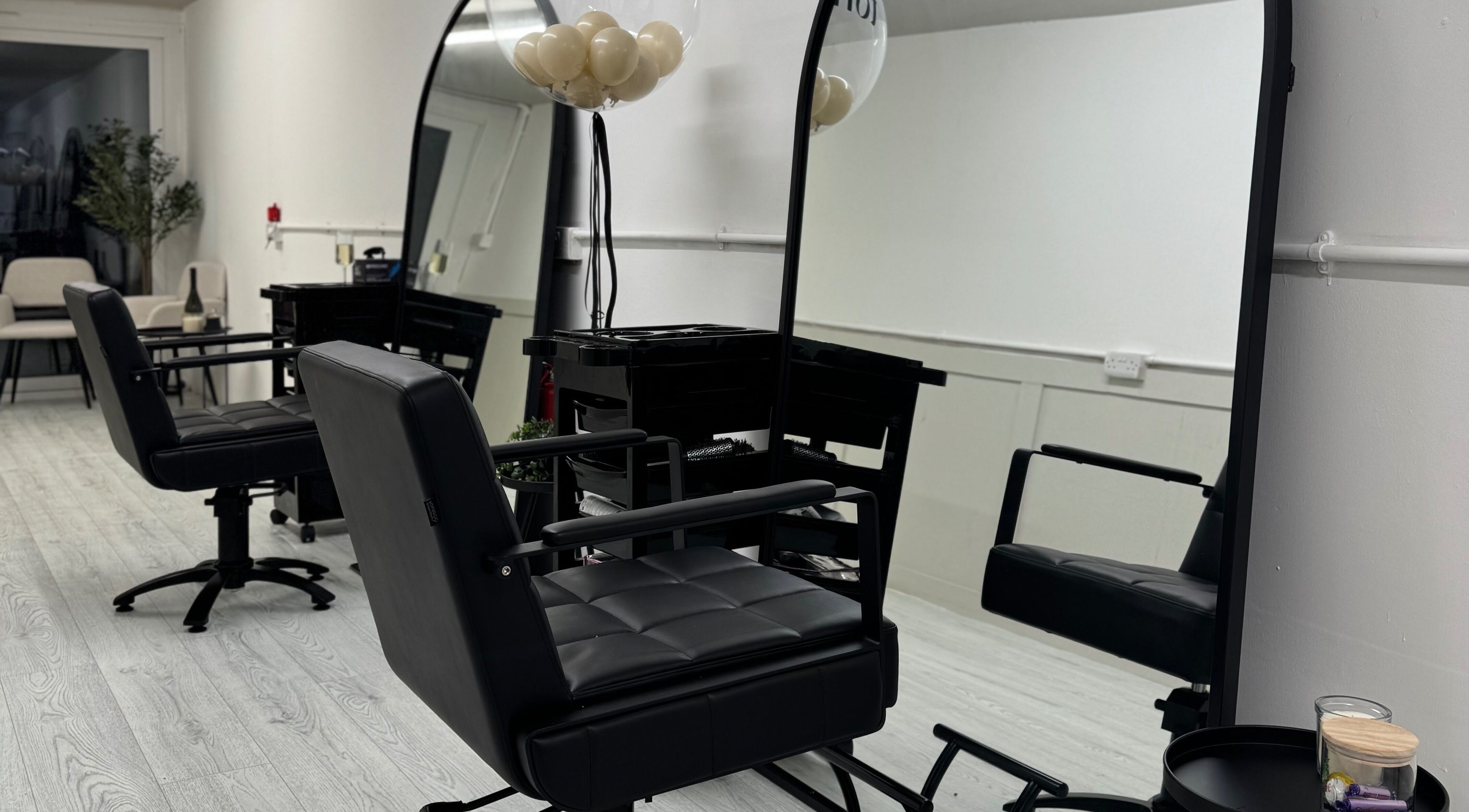 Modern salon chairs and mirrors at The Hair Space, Manchester, England, GB, offering a sleek experience.