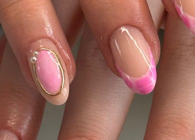 Elegant pink and gold nail art at Pinkies by Pop in Leeds, England, GB showcasing luxurious manicure design.