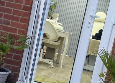 Entrance view of Beauteous beauty salon in Southampton, England, GB featuring elegant interior and potted plants.