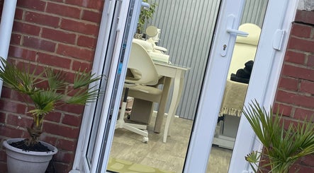 Entrance view of Beauteous beauty salon in Southampton, England, GB featuring elegant interior and potted plants.