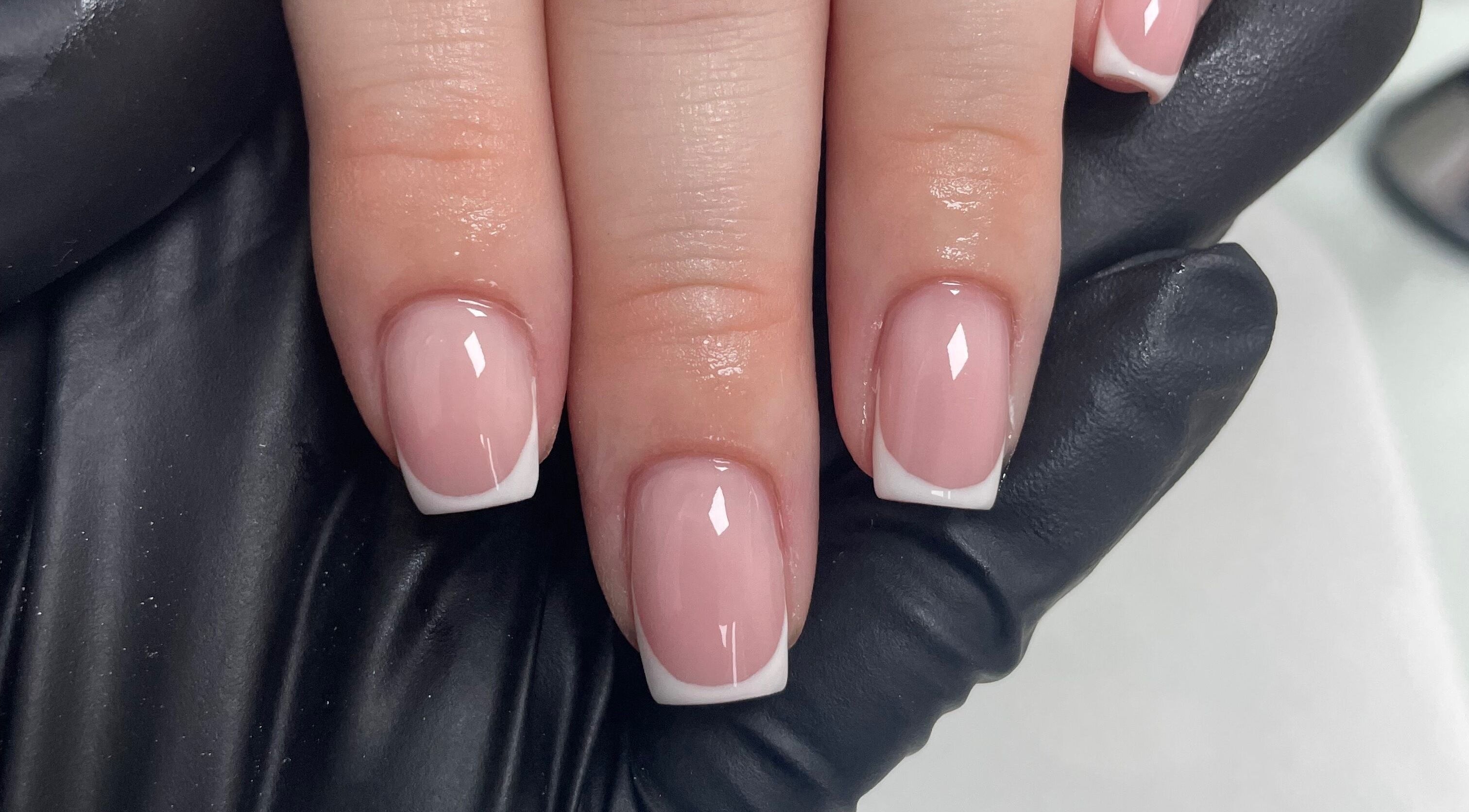 Elegant French manicure on neatly trimmed nails at Beauteous, Southampton, England, GB.