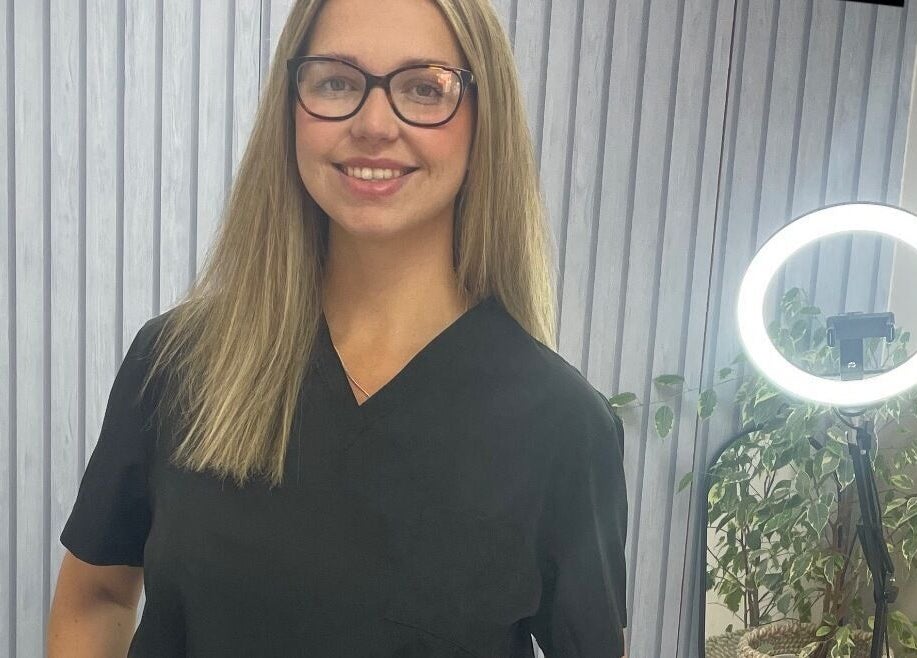 Beauty specialist smiling at Beauteous, Southampton, England, GB in a modern wellness setting.