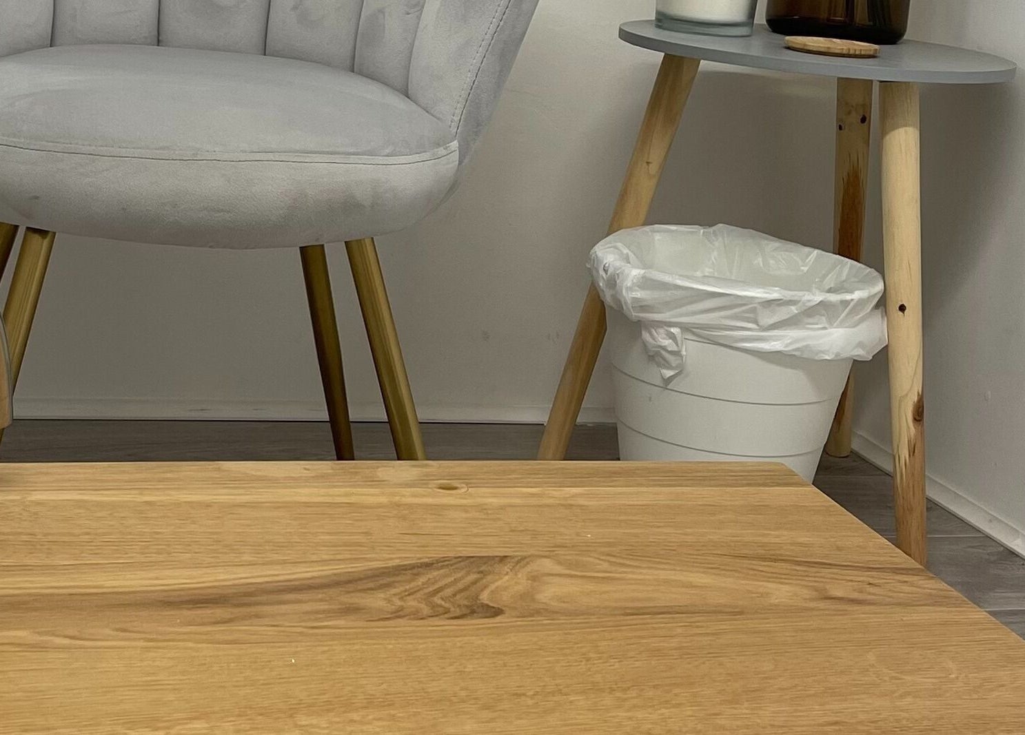 Modern seating area at The Hideaway Salon, Malvern, England, GB, with a stylish chair and side table.