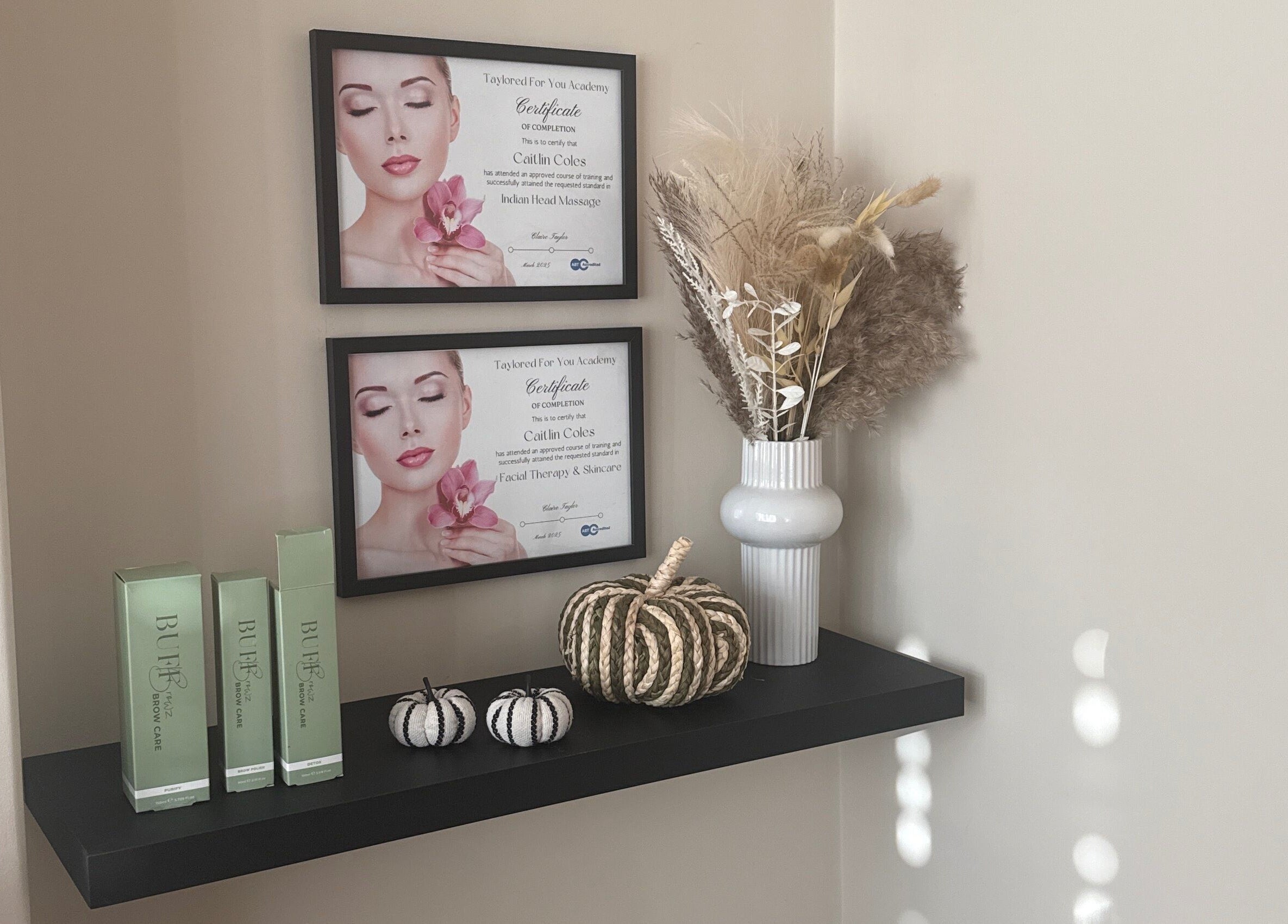 Elegant shelf at Caits Beauty Spot in Barry, GB showcasing beauty products and certificates.