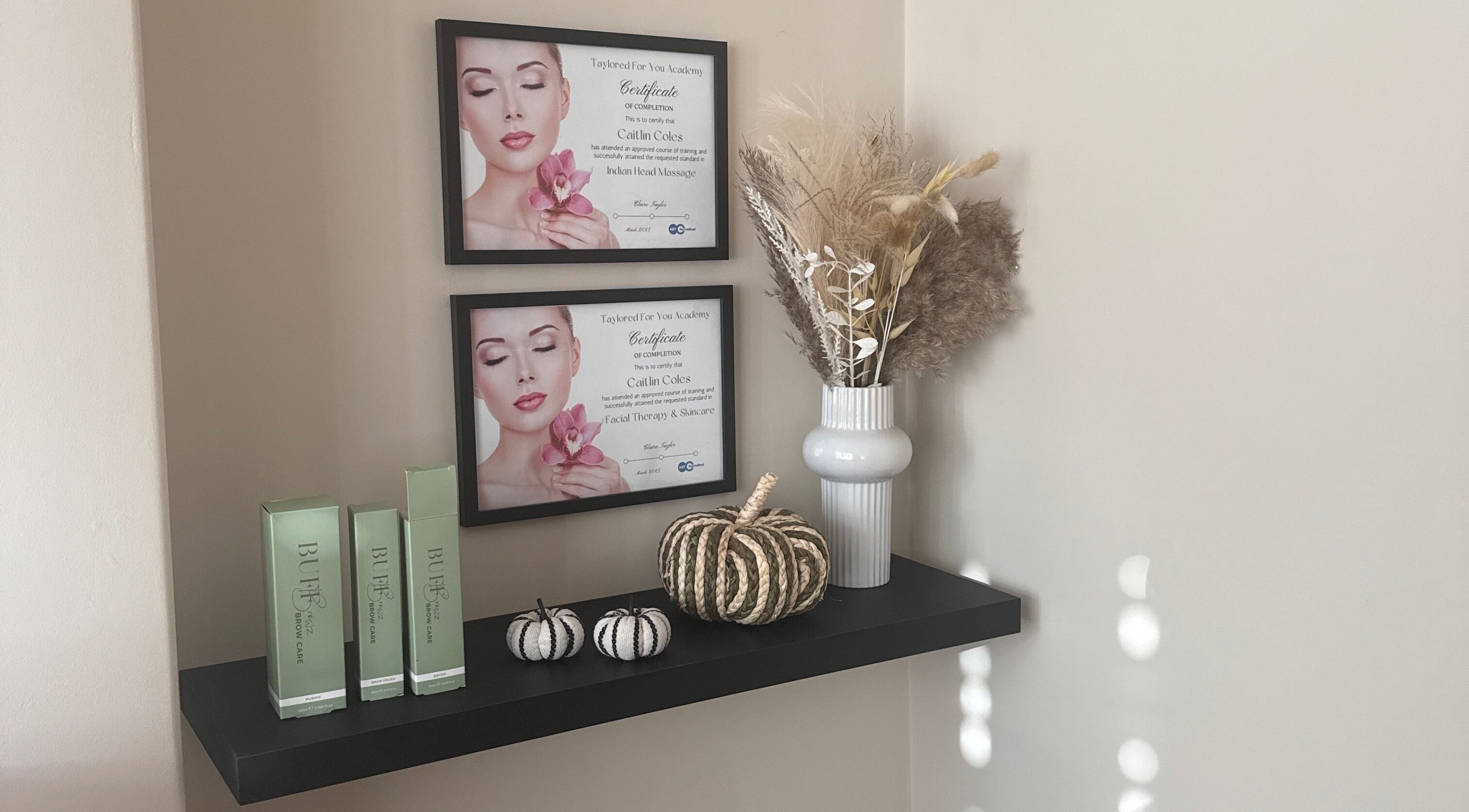 Elegant shelf at Caits Beauty Spot in Barry, GB showcasing beauty products and certificates.