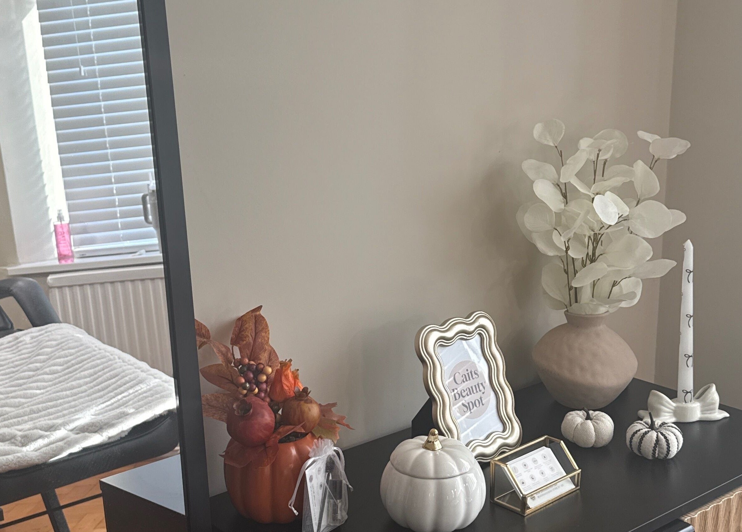 Modern decor at Caits Beauty Spot in Barry, GB, featuring cozy seating and chic autumn accents.