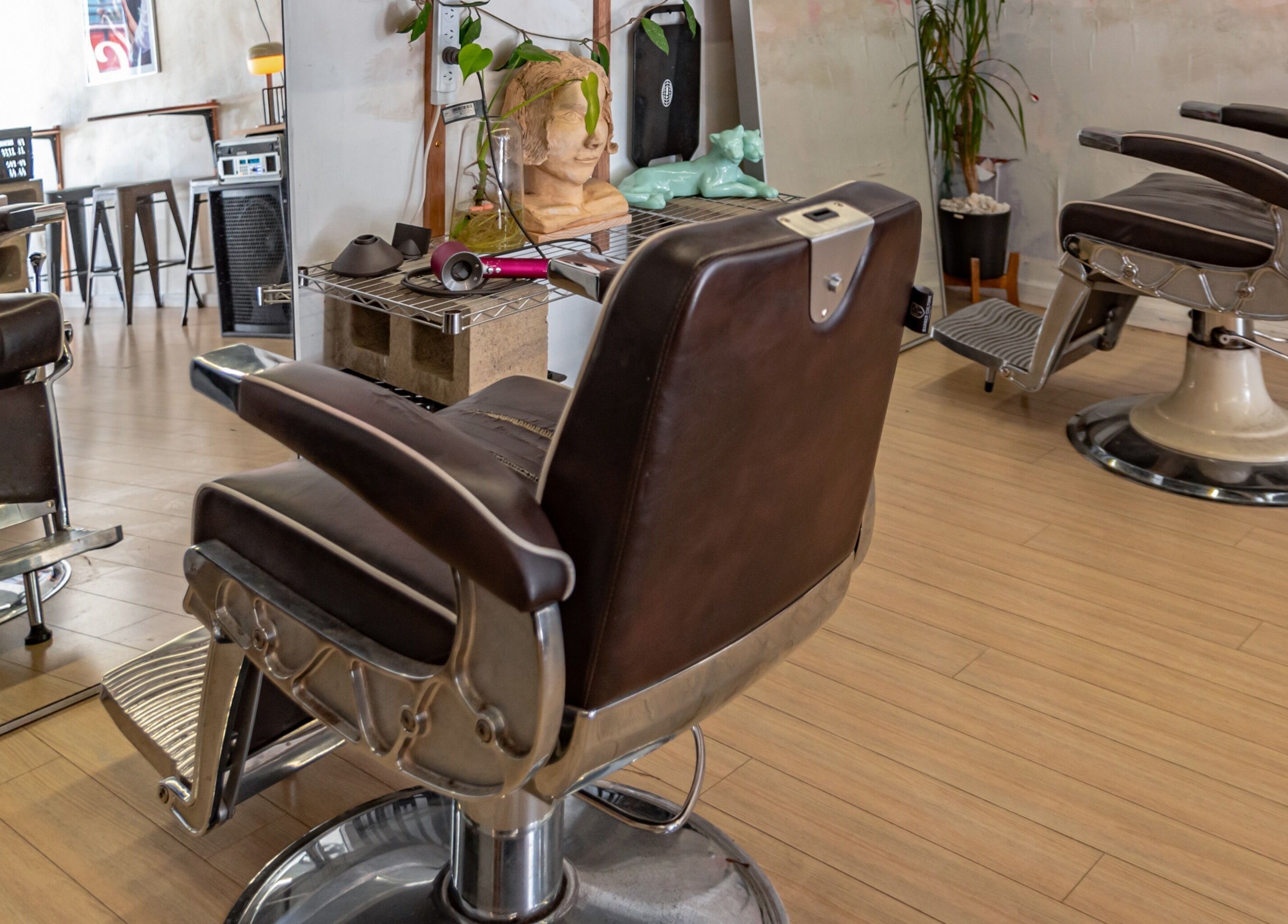 Elegant salon chairs at The Royal Moody, Glenelg, South Australia, AU, showcasing modern beauty space.